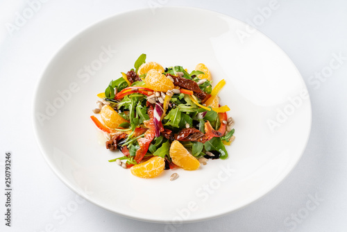 vegan salad with arugula and mandarines