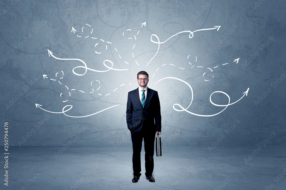 Elegant businessman choosing between directions with winding drawn arrows around
Elegant businessman choosing between directions with winding drawn arrows around