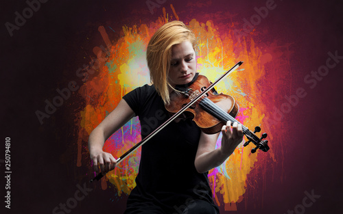 Young classical violinist musician with colorful splotch wallpaper 