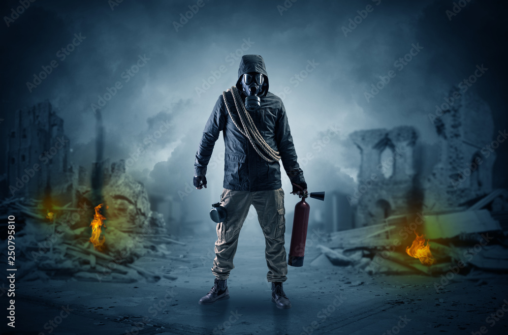 Destroyed place after a catastrophe with man in gas mask and weapon on his hand
Destroyed place after a catastrophe with man in gas mask and weapon on his hand