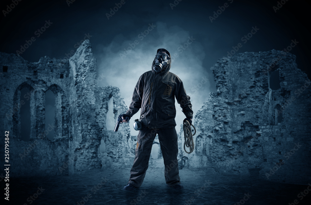 Fototapeta premium Hazard, menace man in a ruined crumbly building with arms on his hand 