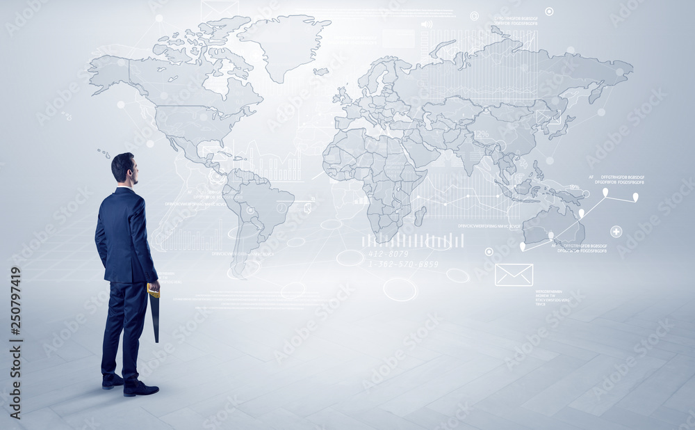 Businessman standing with his back and looking at a worldwide map with objects in his hand
Businessman standing with his back and looking at a worldwide map with objects in his hand