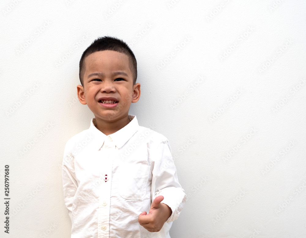 very happy asian boy making thumbs up sign on white background very happy asian boy making thumbs up sign on white background