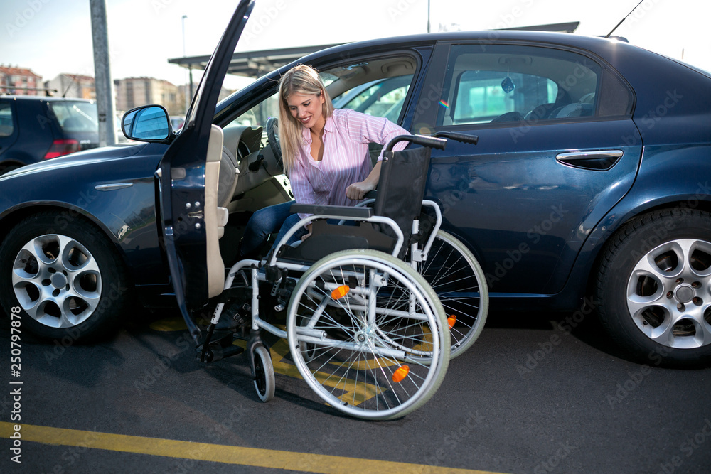 Blonde girl with loss of leg function sitting in the car Blonde girl with loss of leg function sitting in the car