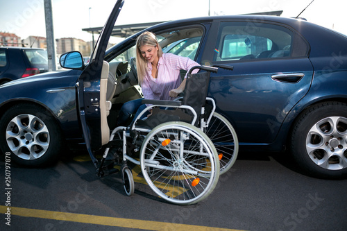 Blonde girl with loss of leg function sitting in the car