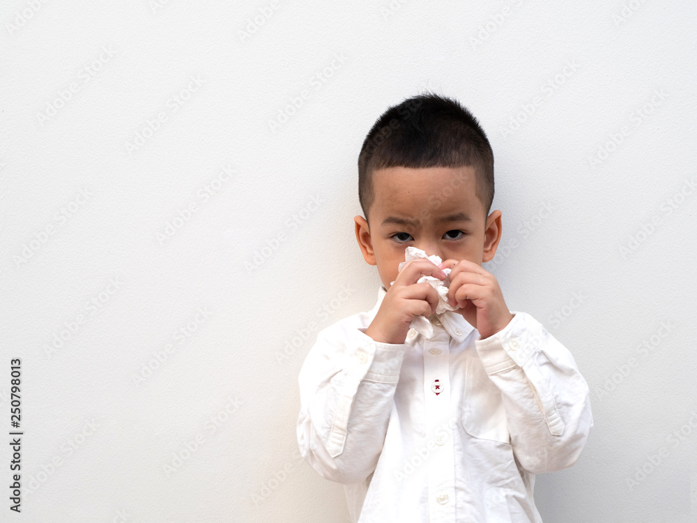 sick asian boy blow his nose into tissue sick asian boy blow his nose into tissue