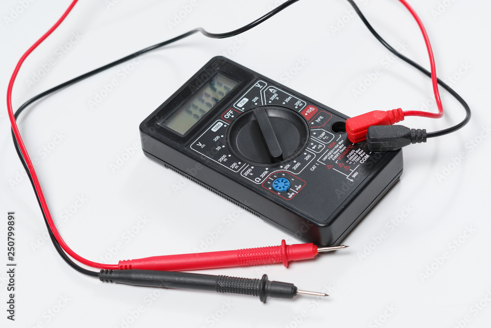 Tool for checking electrical circuits. Digital multimeter on white background Tool for checking electrical circuits. Digital multimeter on white background