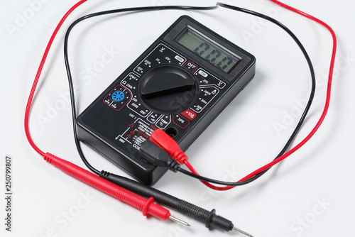 Tool for checking electrical circuits. Digital multimeter on white background