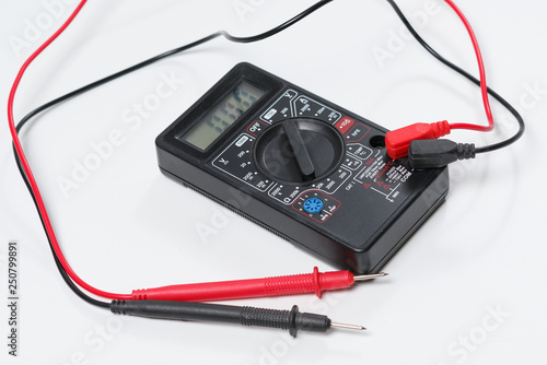 Tool for checking electrical circuits. Digital multimeter on white background