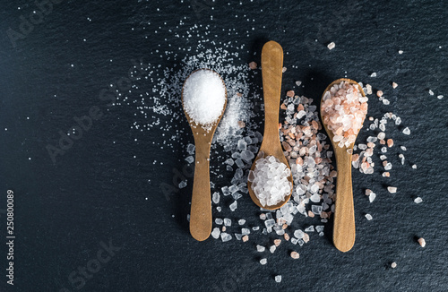 Different types of salt. Top view on three wooden spoons © angelus_liam