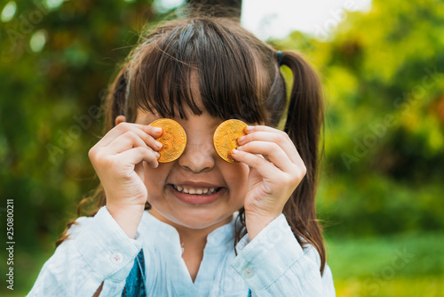 Little girl kid holding bitcoin digital money. photo