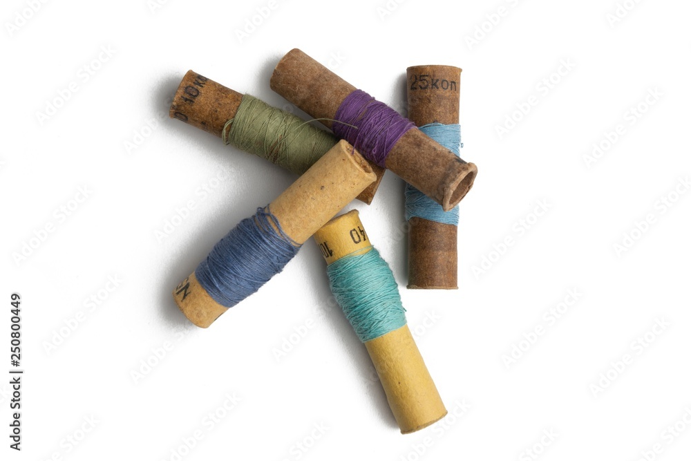 Not full used retro group of thread spools white background sewing tool Not full used retro group of thread spools white background sewing tool