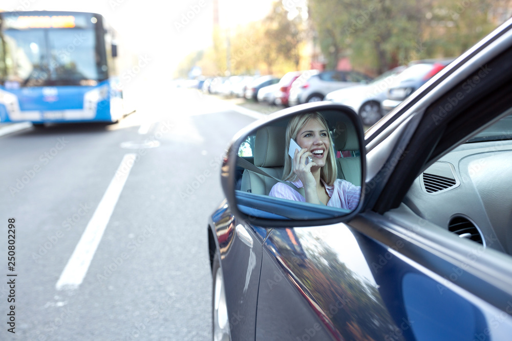 Image of a shocked woman in the side view mirror