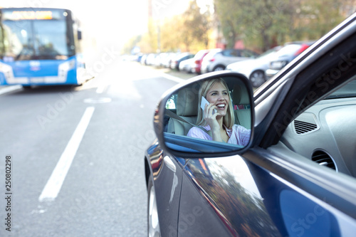 Image of a shocked woman in the side view mirror © didesign
