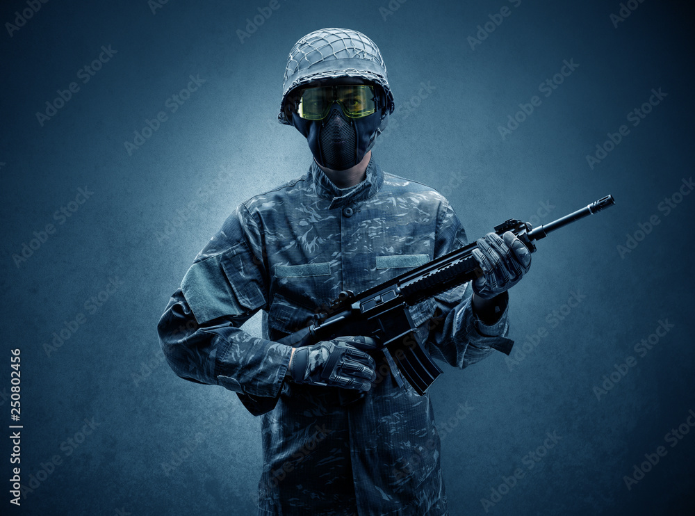 Soldier agent in a dark room with arms on his hand and gas mask
Soldier agent in a dark room with arms on his hand and gas mask