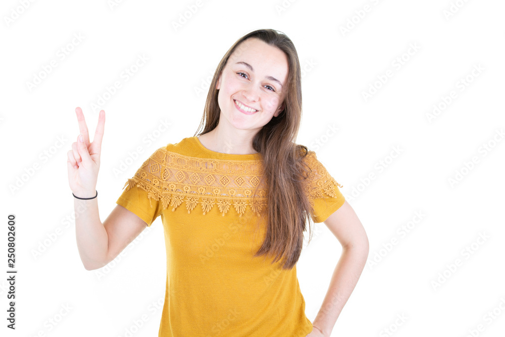 Young smiling brunette woman indoors victory gesture Young smiling brunette woman indoors victory gesture
