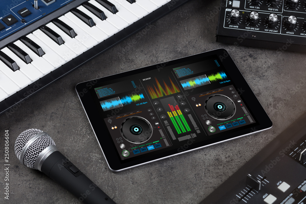 Mixing music on tablet with electronic music instruments concept
