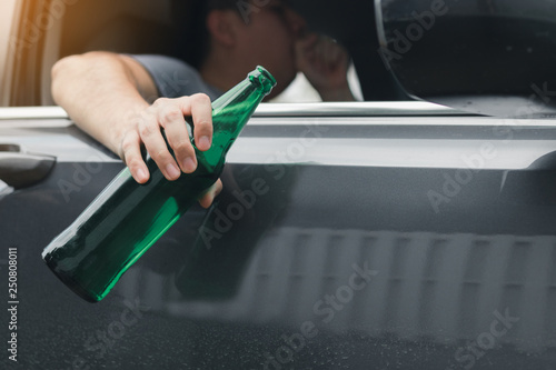 Wallpaper Mural Asian man holding a bottle of beer outside the car while driving. Torontodigital.ca