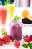 Blueberry smoothies on a white background with berries