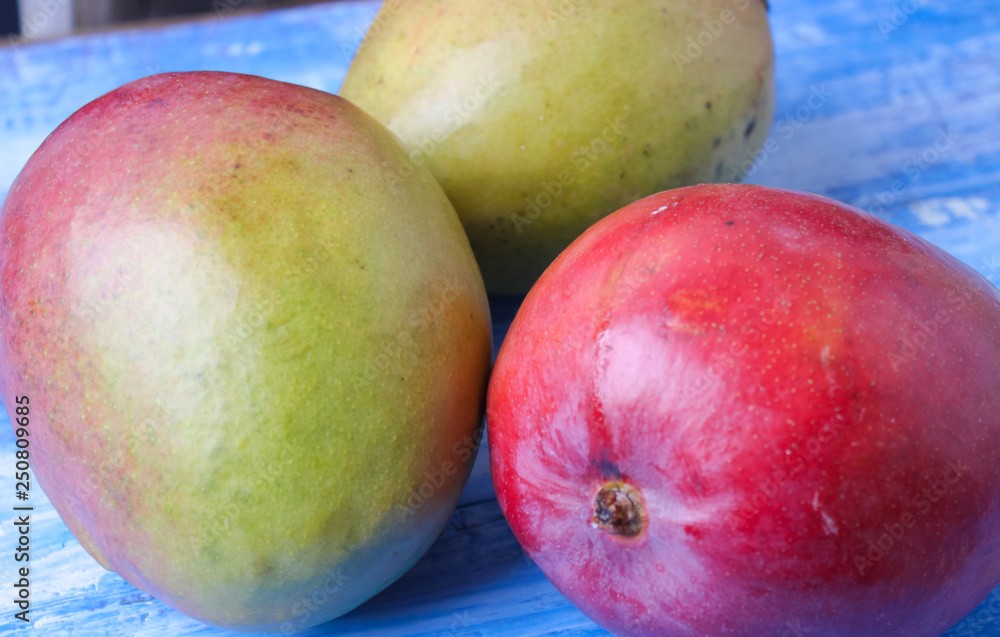 ripe, juicy mango on a wooden background ripe, juicy mango on a wooden background