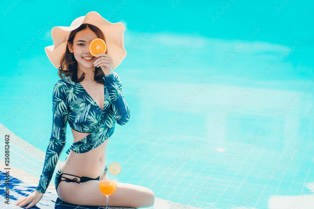 Beautiful Asain women with bikini enjoy summer vacation in the swimming pool. - obrazy, fototapety, plakaty 