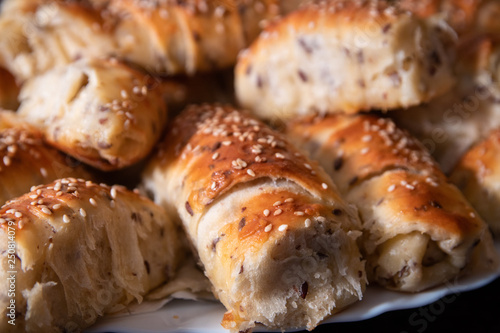 Fresh and hot homemade roll pastry with cheese and sesame