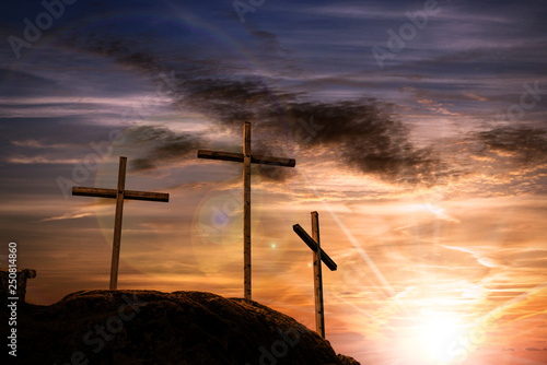 Vászonkép Three crosses on a dramatic sky at sunset
