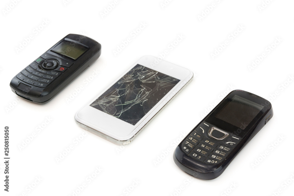 Button mobile phone white smartphone with a broken screen on an isolated background . Development of mobile technologies Button mobile phone white smartphone with a broken screen on an isolated background . Development of mobile technologies