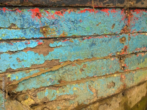 Blue and red cracked plank paint on old boards stock photo