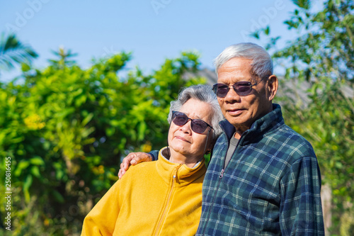 Portrait of romantic elderly man with his wife at home garden. © meeboonstudio