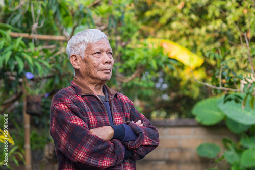 Portrait of senior man standing in his garden.