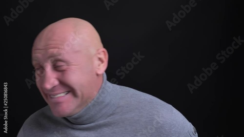 Closeup shoot of adult caucasian man literally dying of laughter being extremely excited and happy in front of the camera photo