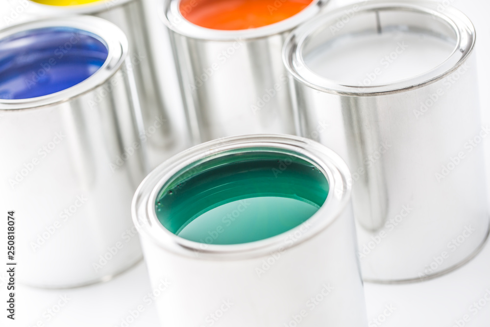 Full of multicolored paint cans on white table Full of multicolored paint cans on white table