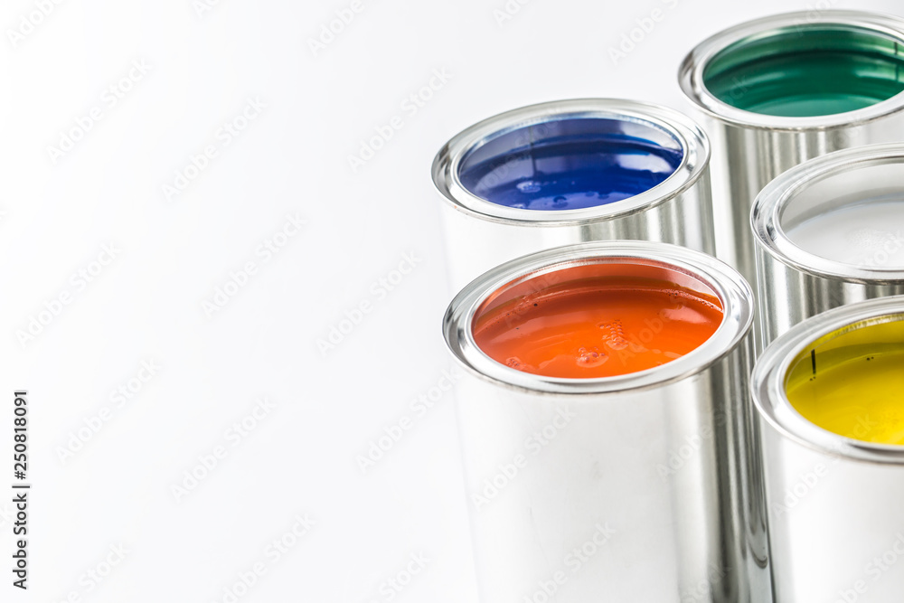 Full of multicolored paint cans on white table Full of multicolored paint cans on white table