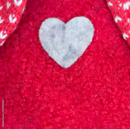 A heart sewn in a red woolen sweater