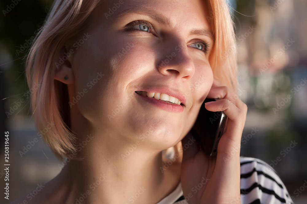 young beautiful girl talking on a cell phone, telephone conversation, walk around the city young beautiful girl talking on a cell phone, telephone conversation, walk around the city