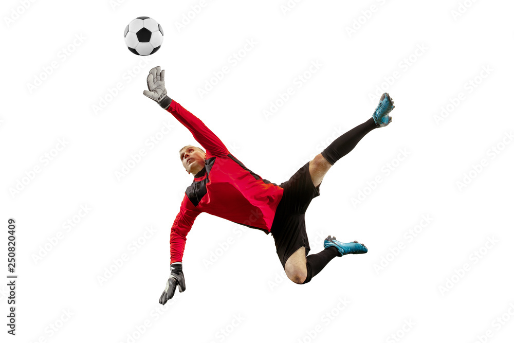 Fototapeta premium Male soccer player goalkeeper catching ball in jump. Silhouette of fit man with ball isolated on white studio background