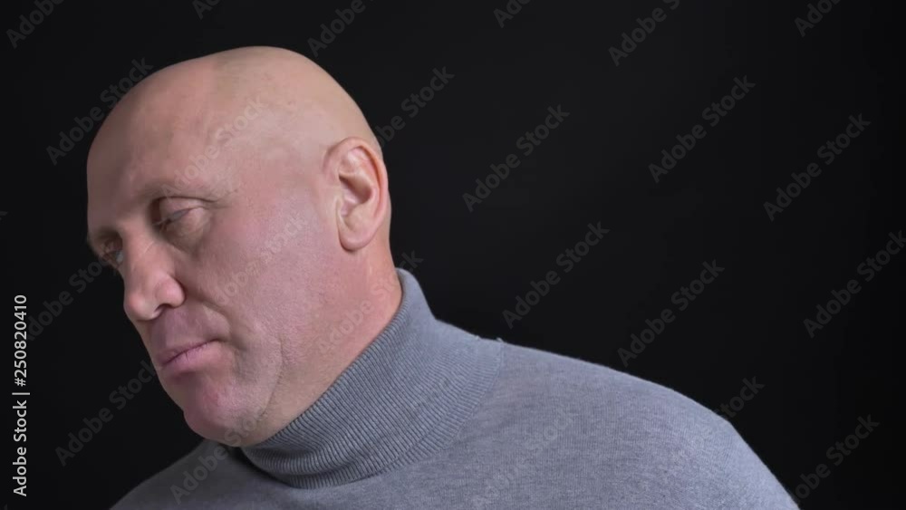 Closeup portrait of middle-aged caucasian man being annoyed and irritated in front of the camera with background isolated on black Closeup portrait of middle-aged caucasian man being annoyed and irritated in front of the camera with background isolated on black