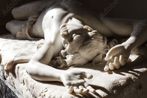 The young man is lying in the sun. Antique sculpture, classical art