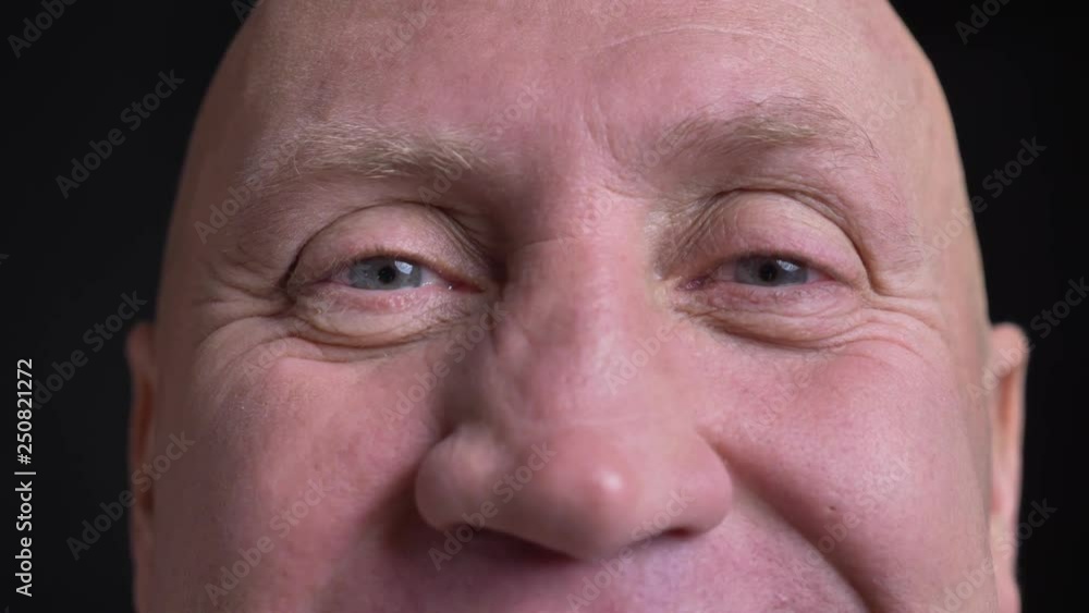 Closeup portrait of middle-aged caucasian man with eyes looking straight at camera with smiling facial expression Closeup portrait of middle-aged caucasian man with eyes looking straight at camera with smiling facial expression