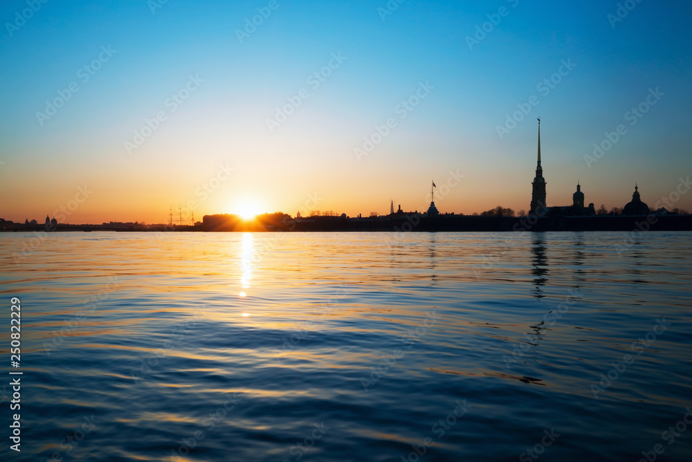 Sunset over the Neva river on the background of Peter and Paul fortress. White night. Saint-Petersburg.