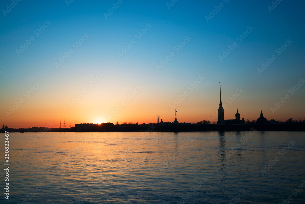 Sunset over the Neva river on the background of Peter and Paul fortress. White night. Saint-Petersburg.