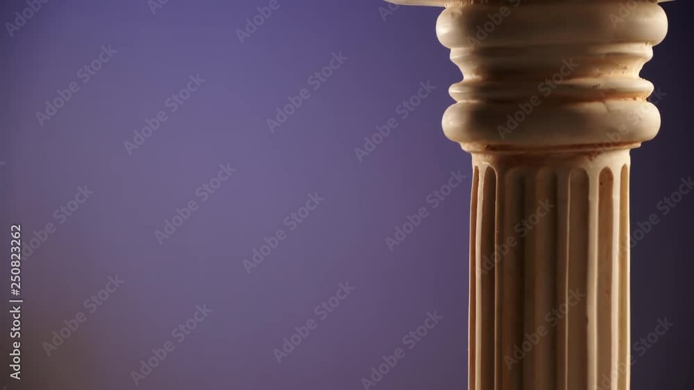 Single ancient greek column rotating slowly on color background, copy space text area Single ancient greek column rotating slowly on color background, copy space text area