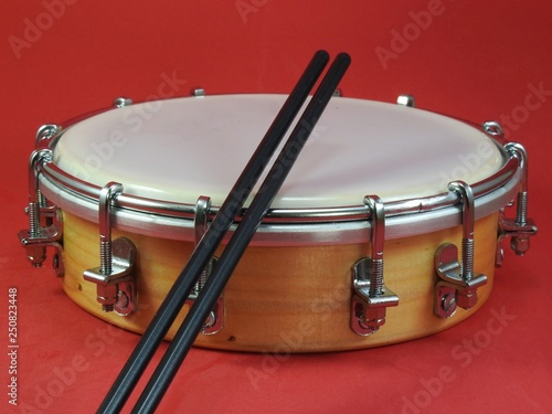 Tamborim and drumstick: a Brazilian percussion musical instrument. It is used to play samba, the famous Brazilian rhythm and has great prominence in the parades of samba schools, in the carnival.