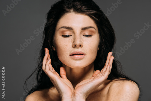 beautiful tender woman posing isolated on grey photo