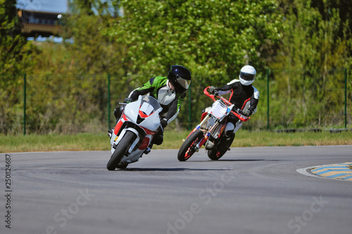 Road racing motorcykel in high speed into a curve, panning shot