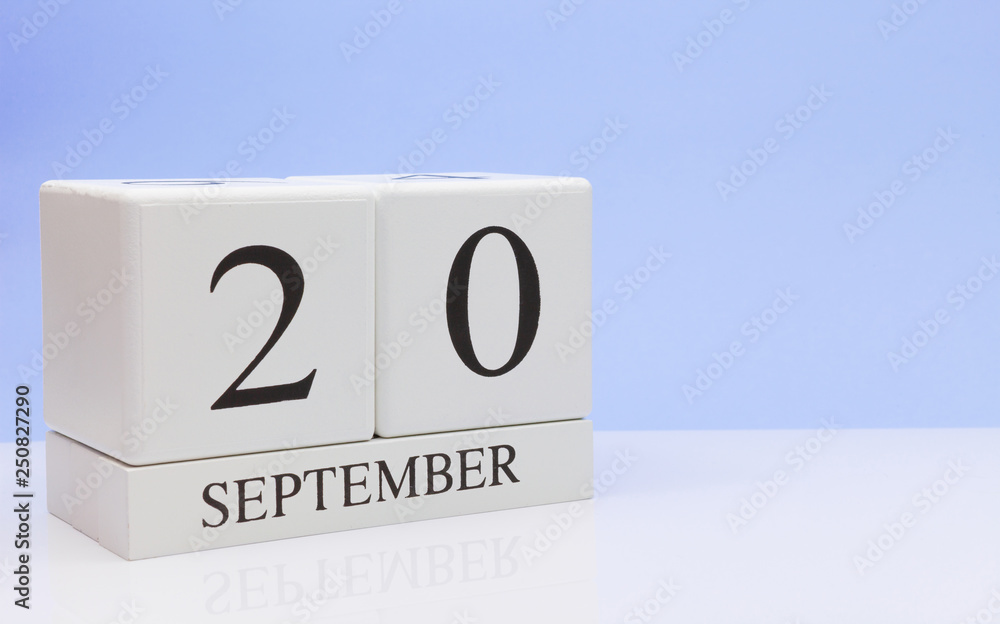 September 20st. Day 20 of month, daily calendar on white table with reflection, with light blue background. Autumn time, empty space for text September 20st. Day 20 of month, daily calendar on white table with reflection, with light blue background. Autumn time, empty space for text