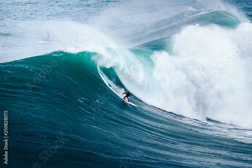 surfing big waves at Nazaré, Portugal