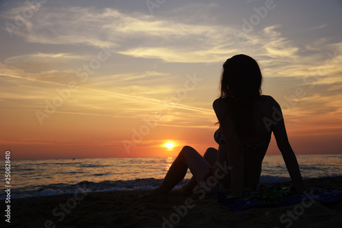 Beautiful woman on the beach at sunset. Woman enjoy on the beach in Greece © Ivan