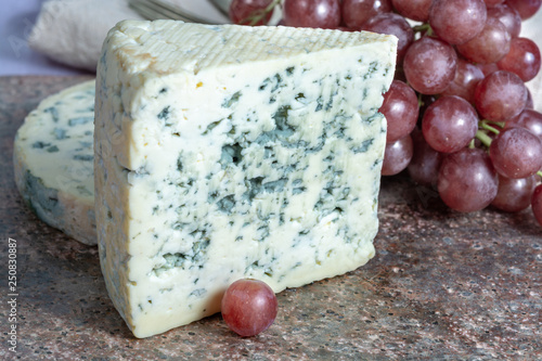 Fourme Ambert and Blue Auvergne semi-hard AOP French blue cheeses made from raw cow milk in Auvergne, France photo